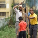 Securing the fence around the tree sapling